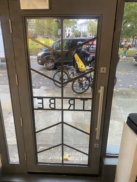 Entrance door with security grille fitted
